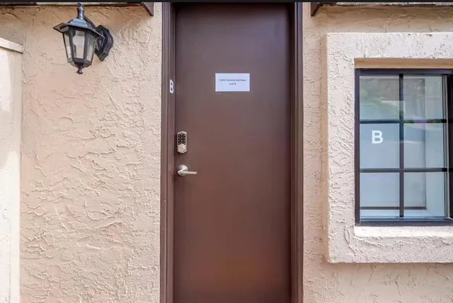 a view of a patio with table and chairs under an umbrella