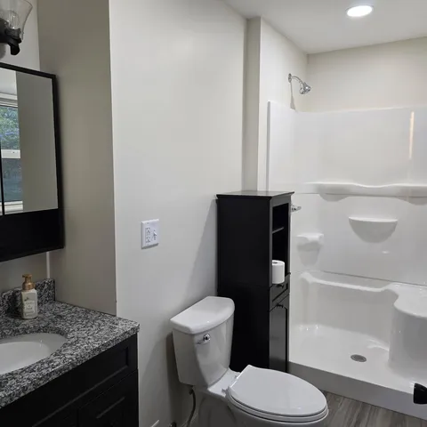 a bathroom with a toilet and a shower