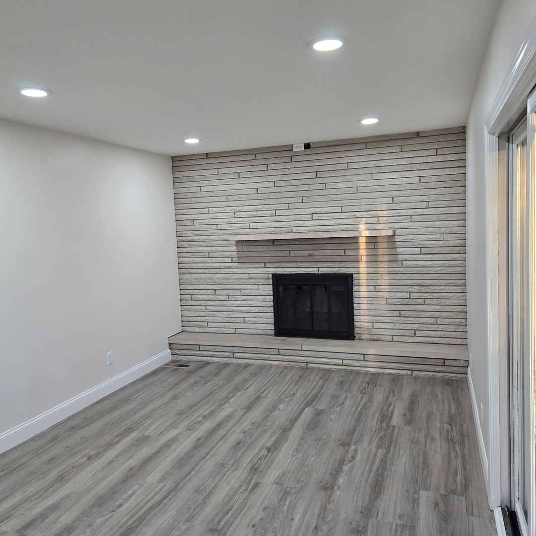 1103 Westview Drive Normal, IL 61761 - Photo 5 of 30 a view of an empty room with wooden floor and a window