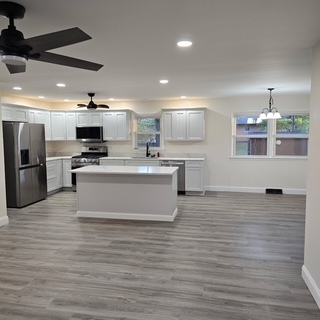 1103 Westview Drive Normal, IL 61761 - Photo 9 of 30 a large kitchen with stainless steel appliances a large counter top a stove a refrigerator and a sink