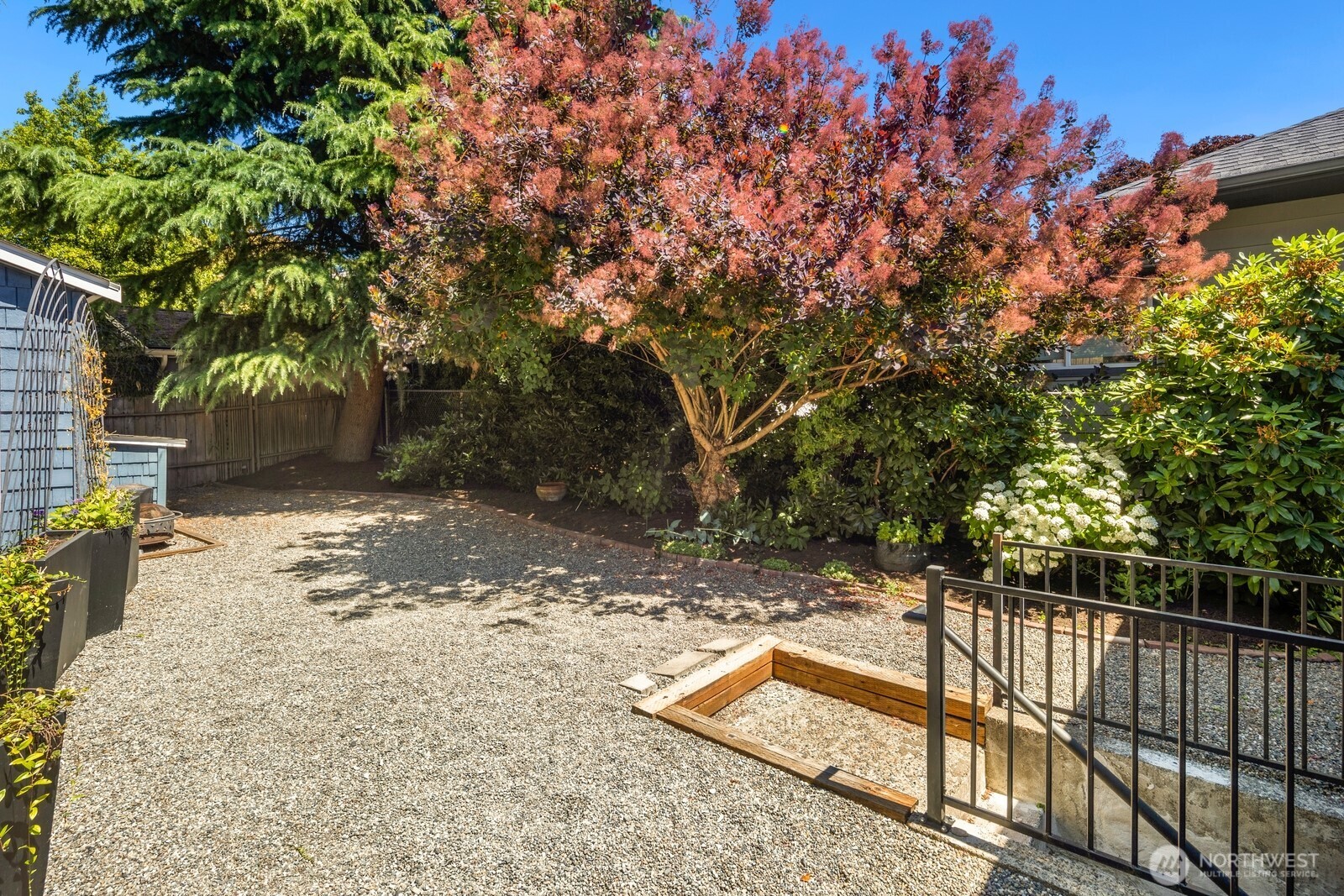 1624 North 50th Street, Unit B Seattle, WA 98103 - Photo 17 of 18 a view of a yard with wooden fence
