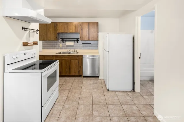a kitchen with a stove top oven cabinets and a refrigerator