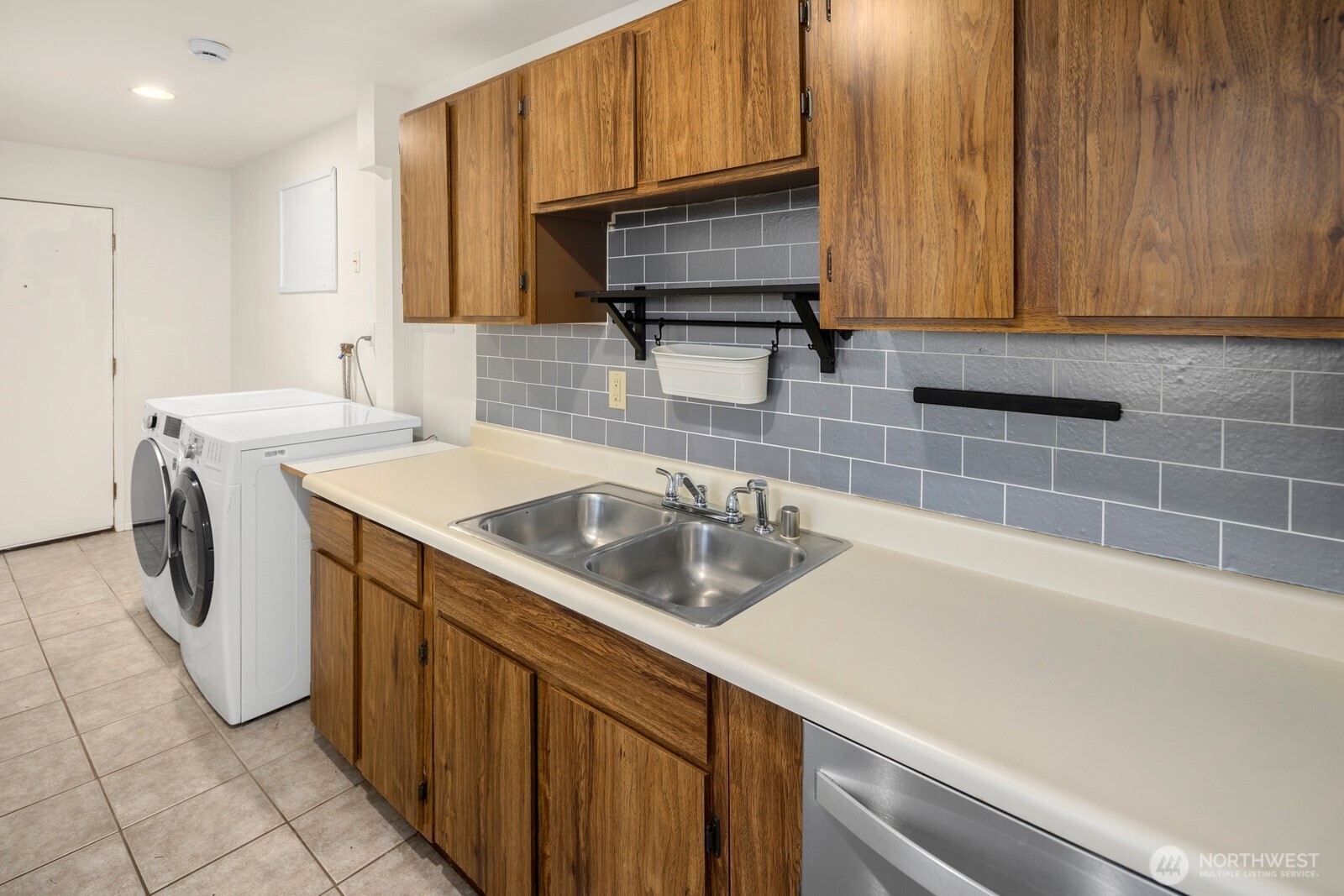 1624 North 50th Street, Unit B Seattle, WA 98103 - Photo 7 of 18 a kitchen with a sink cabinets and appliances