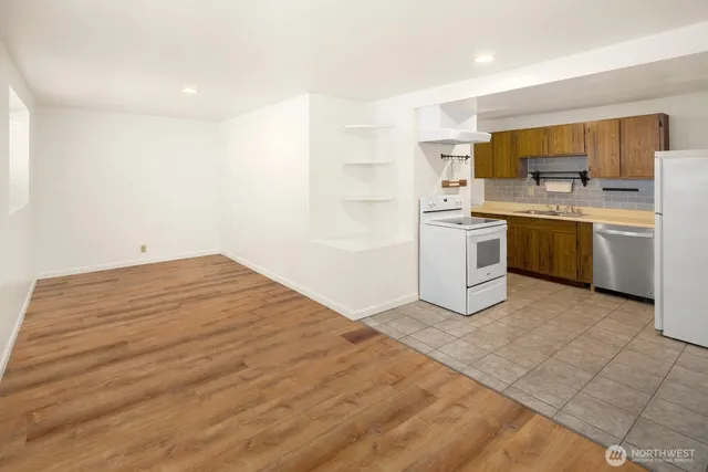 a room with a bed cabinets and a kitchen sink