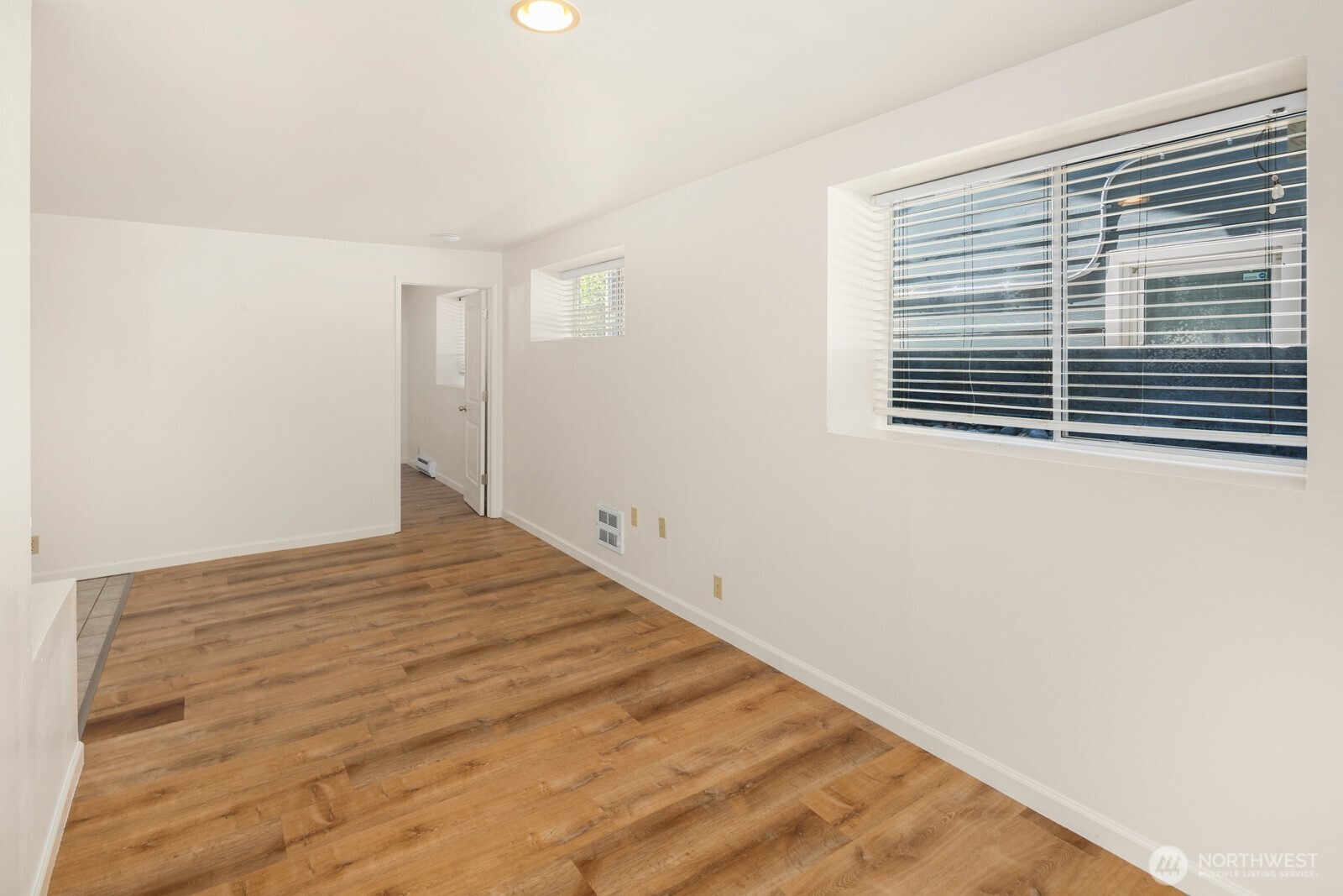 1624 North 50th Street, Unit B Seattle, WA 98103 - Photo 9 of 18 a view of empty room with wooden floor and fan