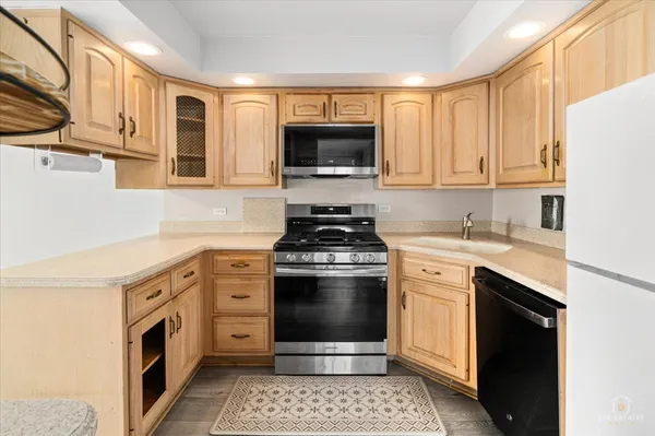 a kitchen with stainless steel appliances granite countertop a stove a sink and a microwave