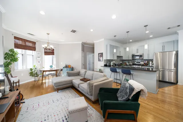 a living room with furniture and kitchen view