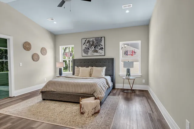 a spacious bedroom with a bed and a window