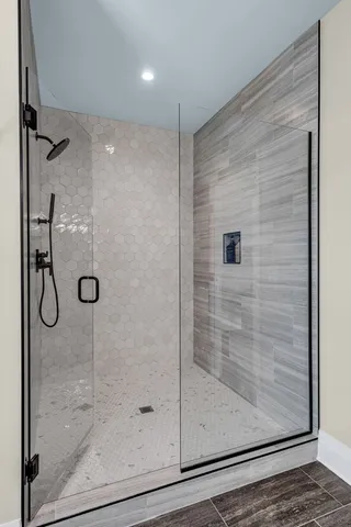 a bathroom with a glass shower door