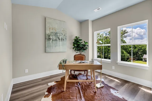 a workspace with furniture and a large window