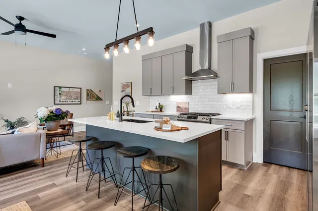 a kitchen with stainless steel appliances a sink stove and refrigerator