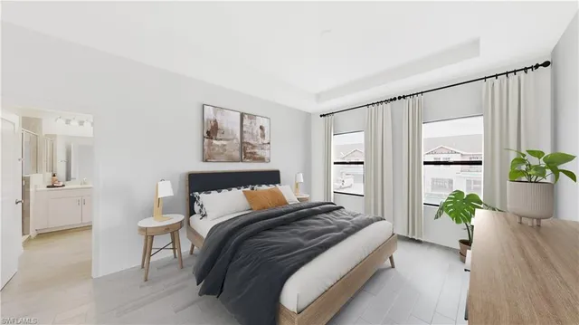 a bedroom with a bed and a potted plant