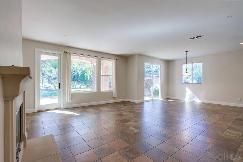 11674 Creek Road Poway, CA 92064 - Photo 19 of 70 a view of an empty room with a fireplace and a window