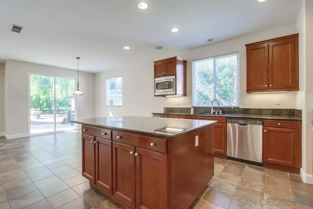 11674 Creek Road Poway, CA 92064 - Photo 22 of 70 a kitchen with stainless steel appliances granite countertop a sink stove and cabinets