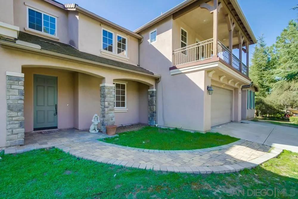 11674 Creek Road Poway, CA 92064 - Photo 3 of 70 a view of a white house with a small yard and large tree