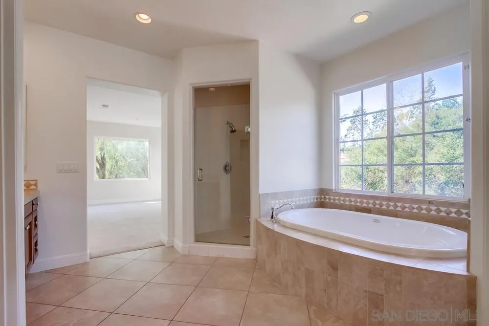11674 Creek Road Poway, CA 92064 - Photo 31 of 70 a spacious bathroom with bathtub and a shower