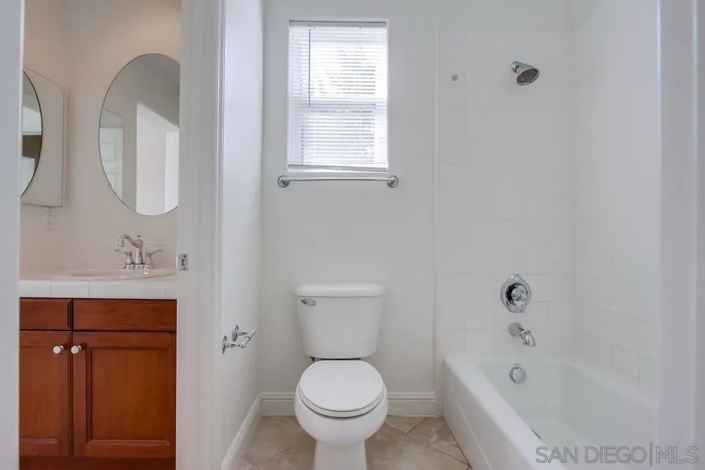 11674 Creek Road Poway, CA 92064 - Photo 39 of 70 a bathroom with a toilet sink and mirror