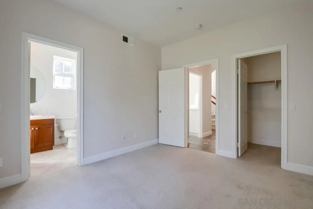 11674 Creek Road Poway, CA 92064 - Photo 47 of 70 an empty room with closet and wooden door