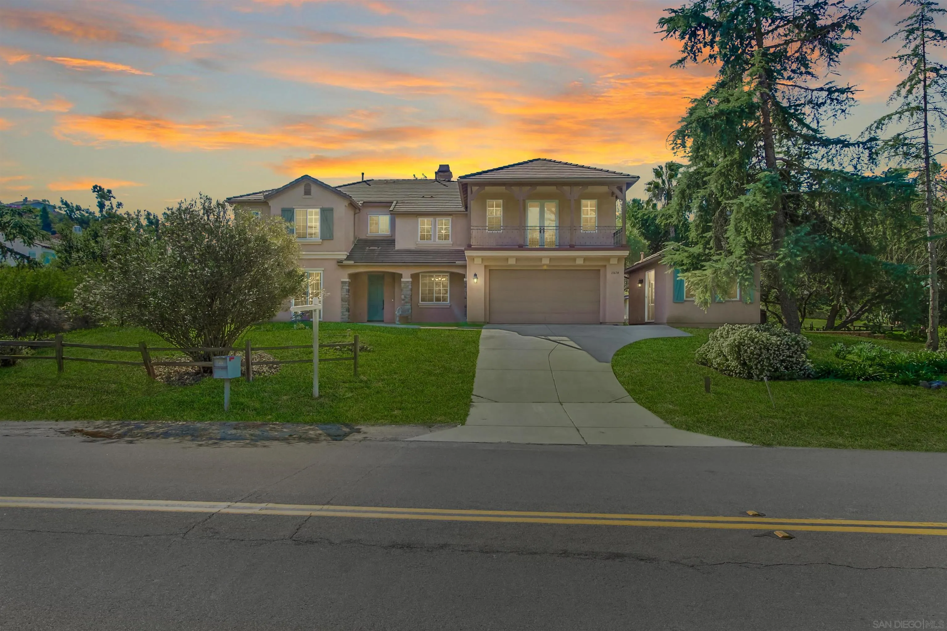 11674 Creek Road Poway, CA 92064 - Photo 8 of 70 a front view of a house with a yard and trees