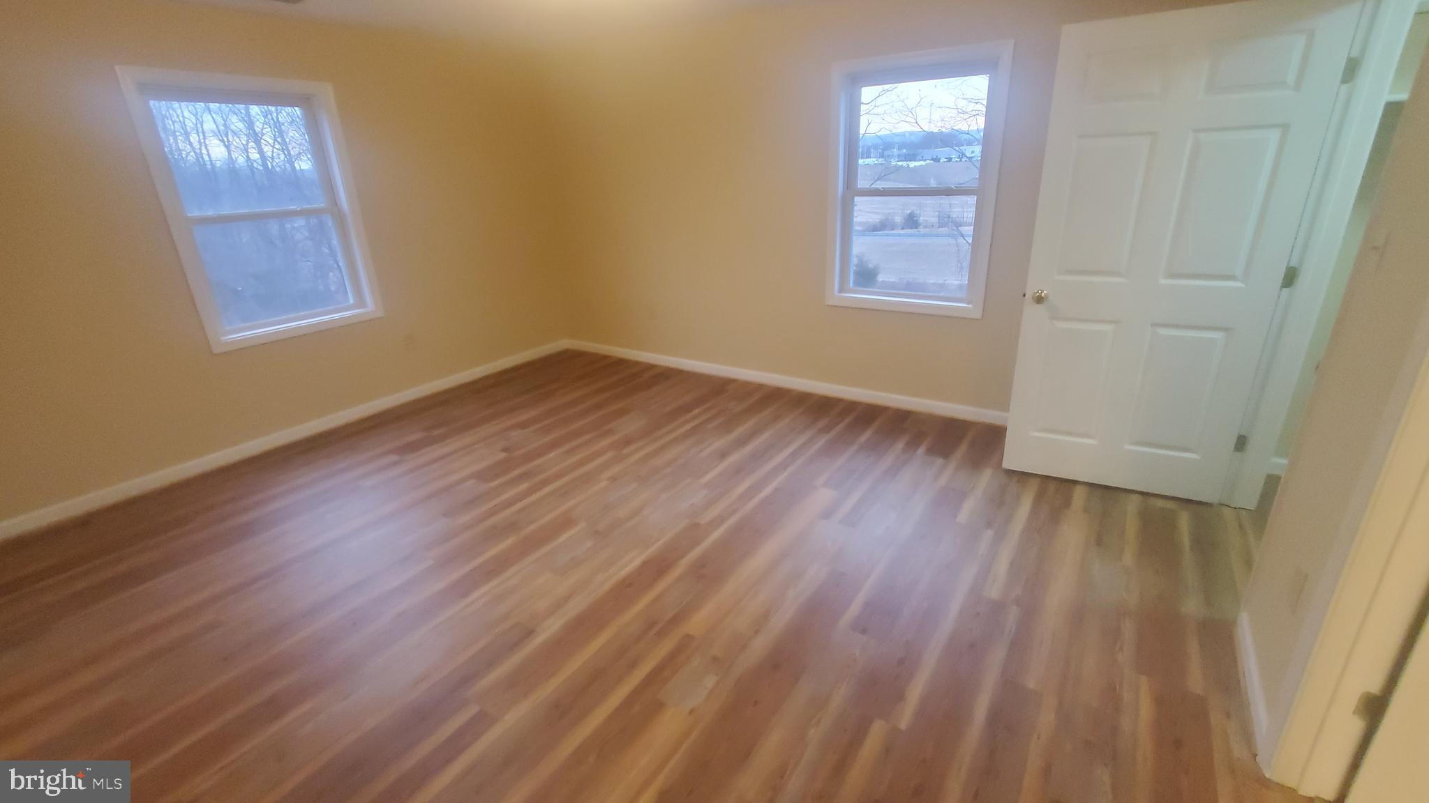 1292 South Ox Road Woodstock, VA 22664 - Photo 3 of 24 a view of an empty room with wooden floor and a window