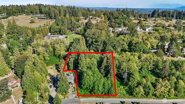 an aerial view of residential house with an outdoor space and seating