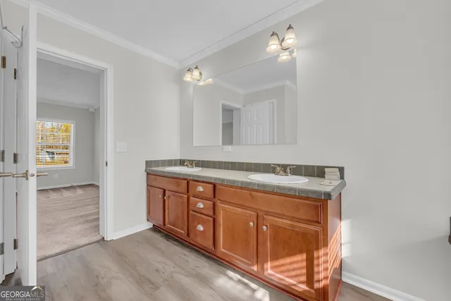 a spacious bathroom with a sink and a mirror