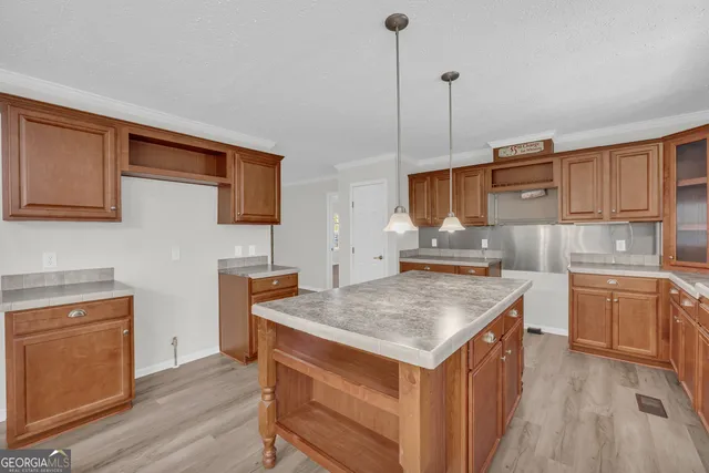 a kitchen with a stove a sink and a refrigerator