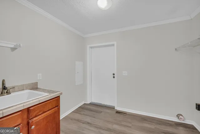 a view of utility room with wooden floor