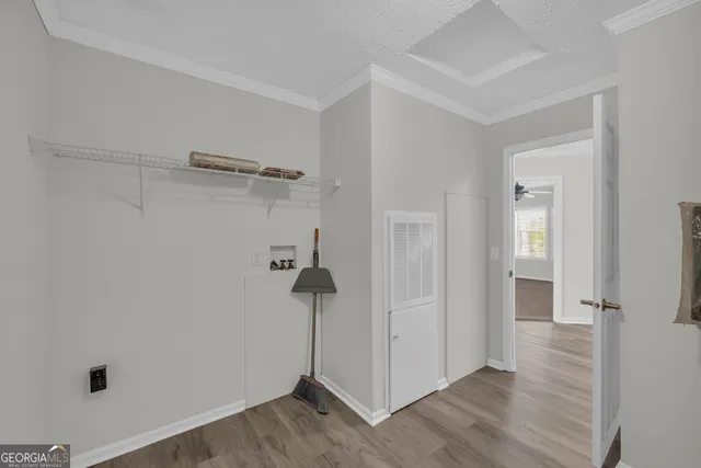 a view of a room with wooden floor