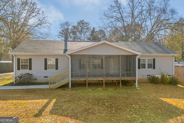 a view of a house with a yard and sitting area
