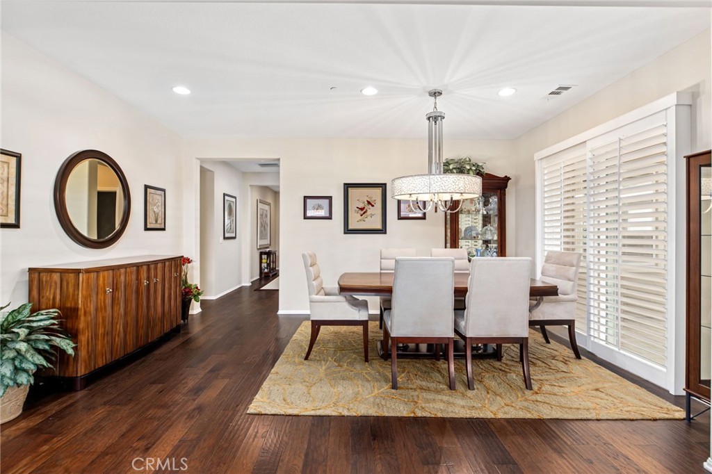 28386 Fox Ridge Cove Menifee, CA 92585 - Photo 11 of 48 a view of a dining room with furniture window and wooden floor