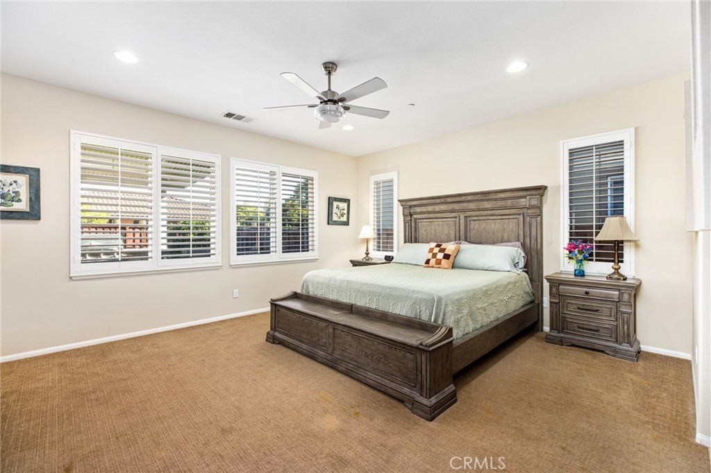 28386 Fox Ridge Cove Menifee, CA 92585 - Photo 20 of 48 a bed sitting in a spacious bedroom next to a window