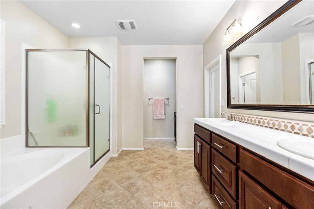 28386 Fox Ridge Cove Menifee, CA 92585 - Photo 22 of 48 a bathroom with a sink and a mirror