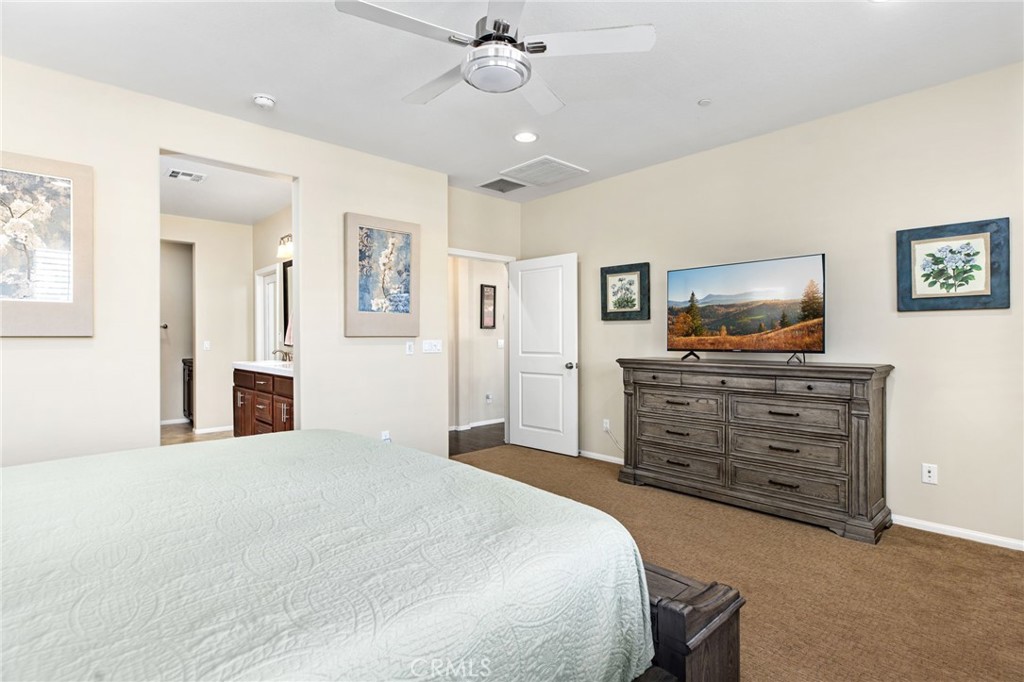 28386 Fox Ridge Cove Menifee, CA 92585 - Photo 25 of 48 a bedroom with a bed and furniture