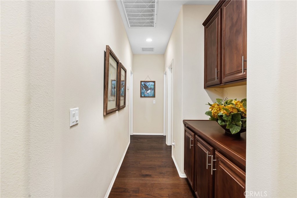 28386 Fox Ridge Cove Menifee, CA 92585 - Photo 26 of 48 a hallway with front door and wooden floor