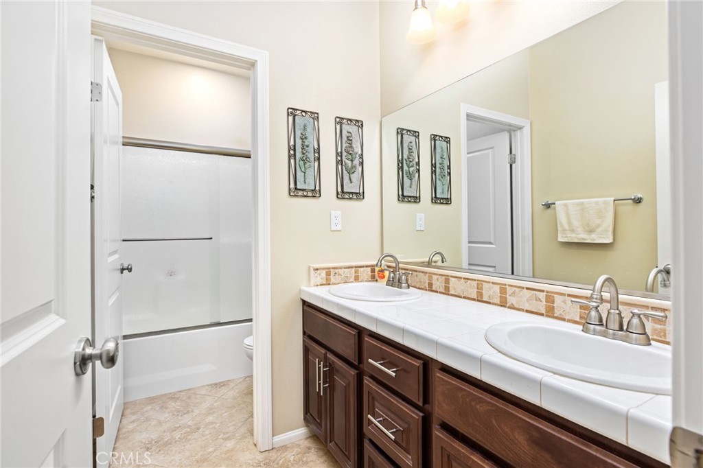 28386 Fox Ridge Cove Menifee, CA 92585 - Photo 29 of 48 a bathroom with a sink and a mirror