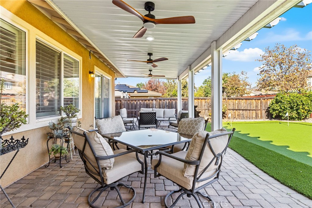 28386 Fox Ridge Cove Menifee, CA 92585 - Photo 39 of 48 a dining room with furniture and a swimming pool