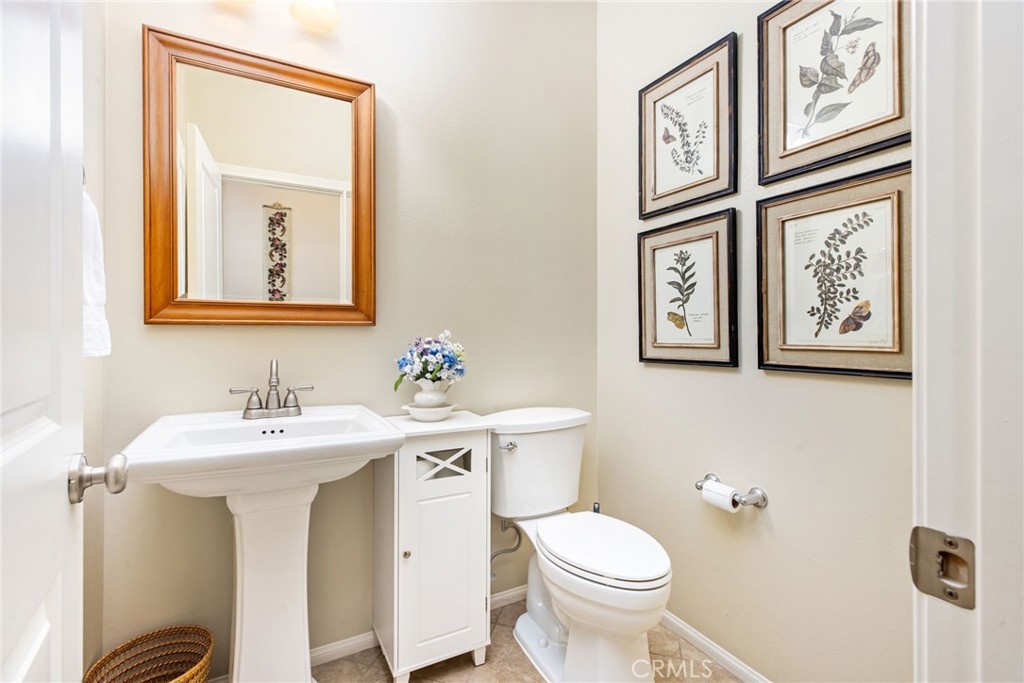 28386 Fox Ridge Cove Menifee, CA 92585 - Photo 7 of 48 a bathroom with a toilet sink and mirror