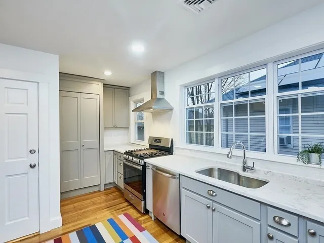 a kitchen that has a sink stove and cabinets