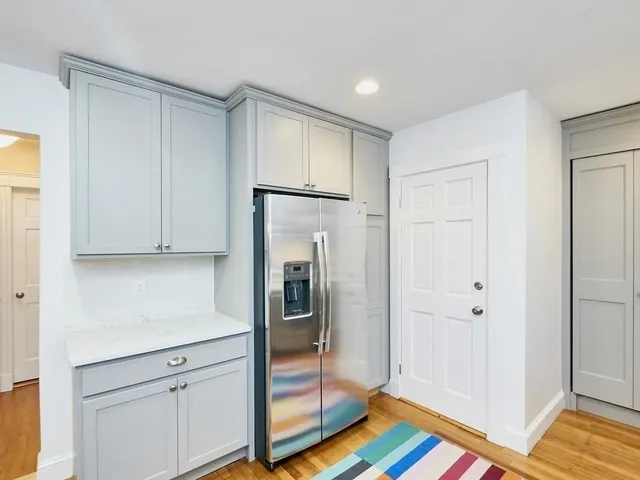 a kitchen with white cabinets and stainless steel appliances