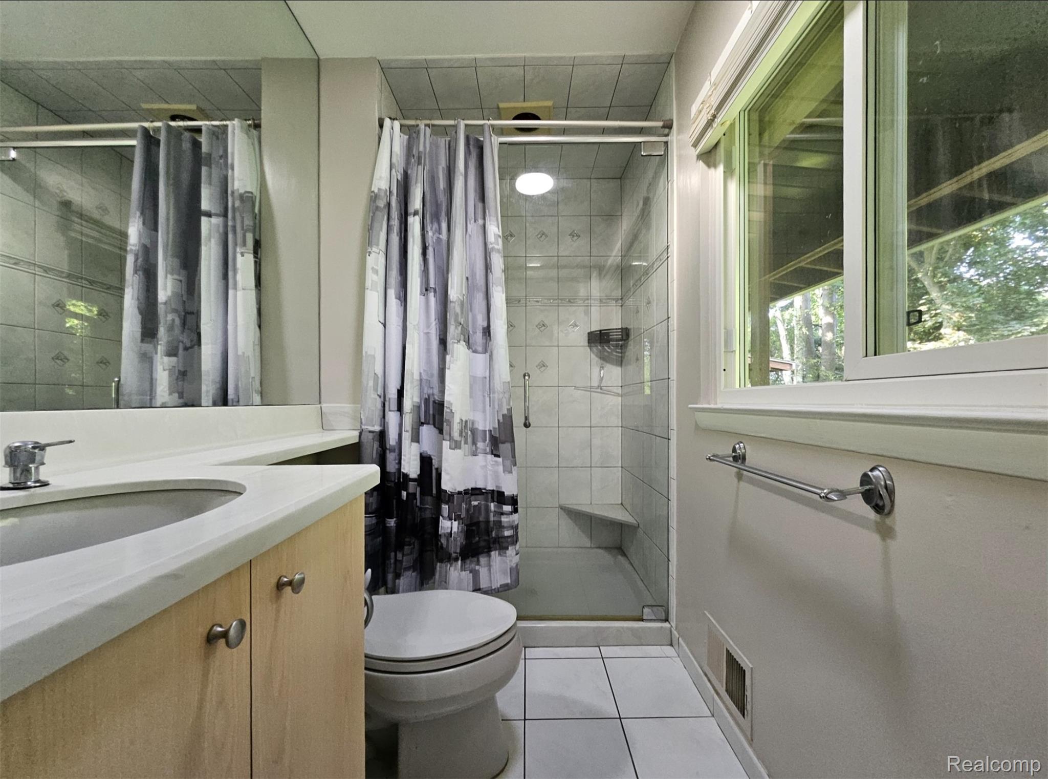 7120 Pebblecreek Road West Bloomfield, MI 48322 - Photo 25 of 31 Full bathroom featuring a glass-enclosed shower with tiled walls and a built-in bench