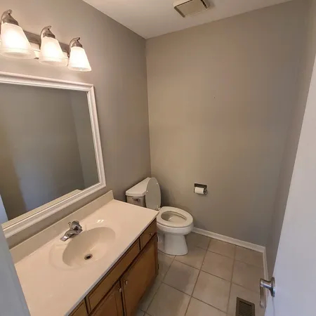a bathroom with a sink a toilet and mirror