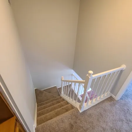 a view of a hallway with staircase