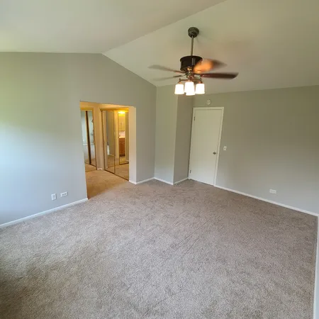 a view of a chandelier fan and a chandelier fan in an empty room