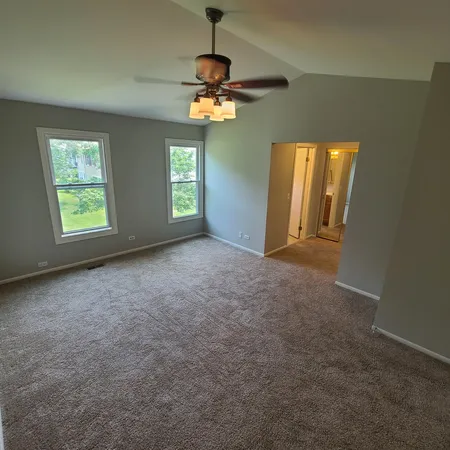 a view of a livingroom with a ceiling fan and window