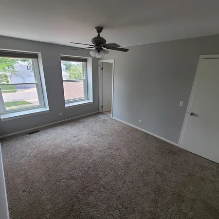 an empty room with a empty space and windows