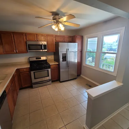 a kitchen with granite countertop a stove a sink and a microwave
