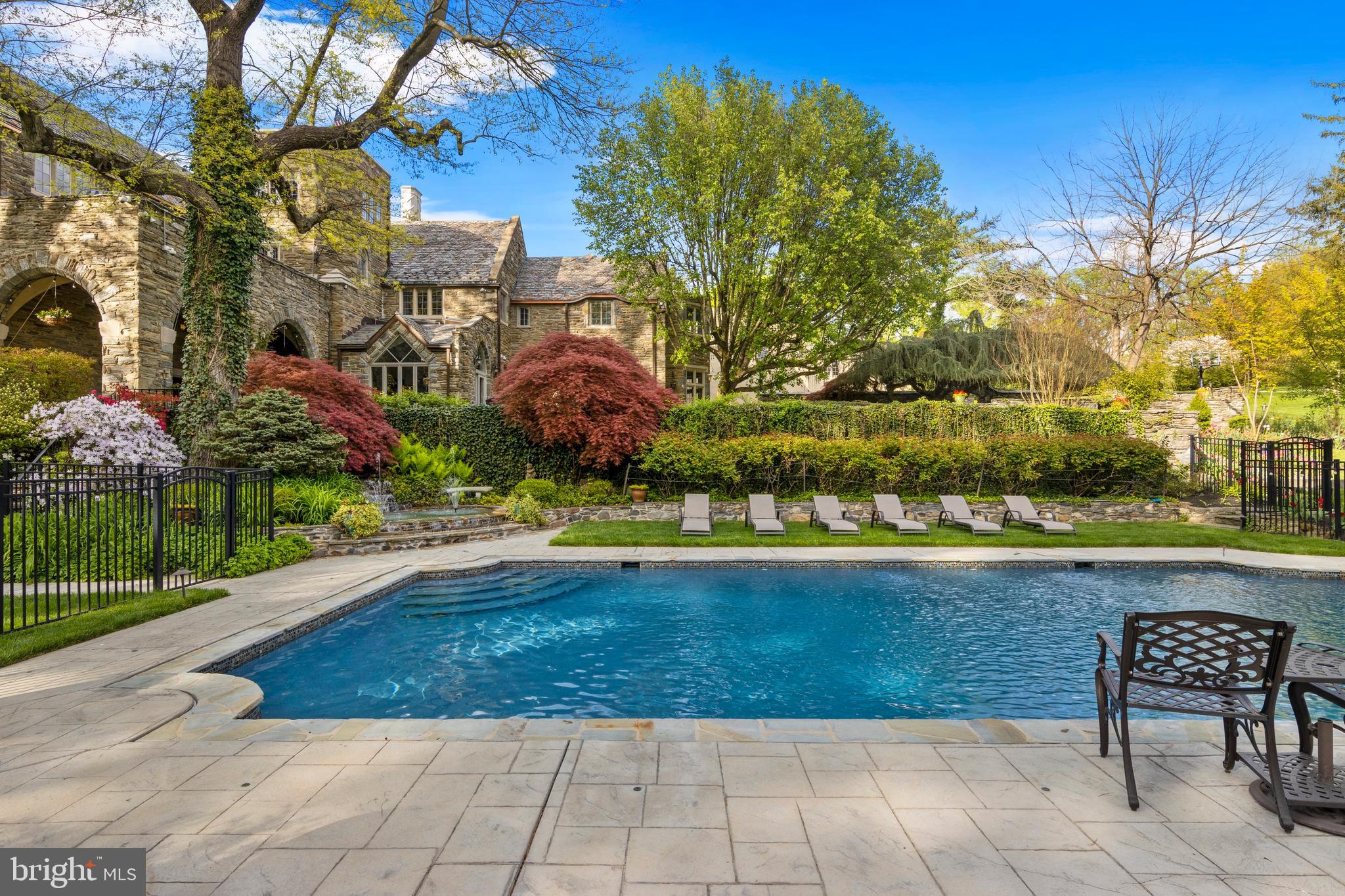 209 Tower Road Villanova, PA 19085 - Photo 84 of 110 Large tiled patio and grass surround the pool