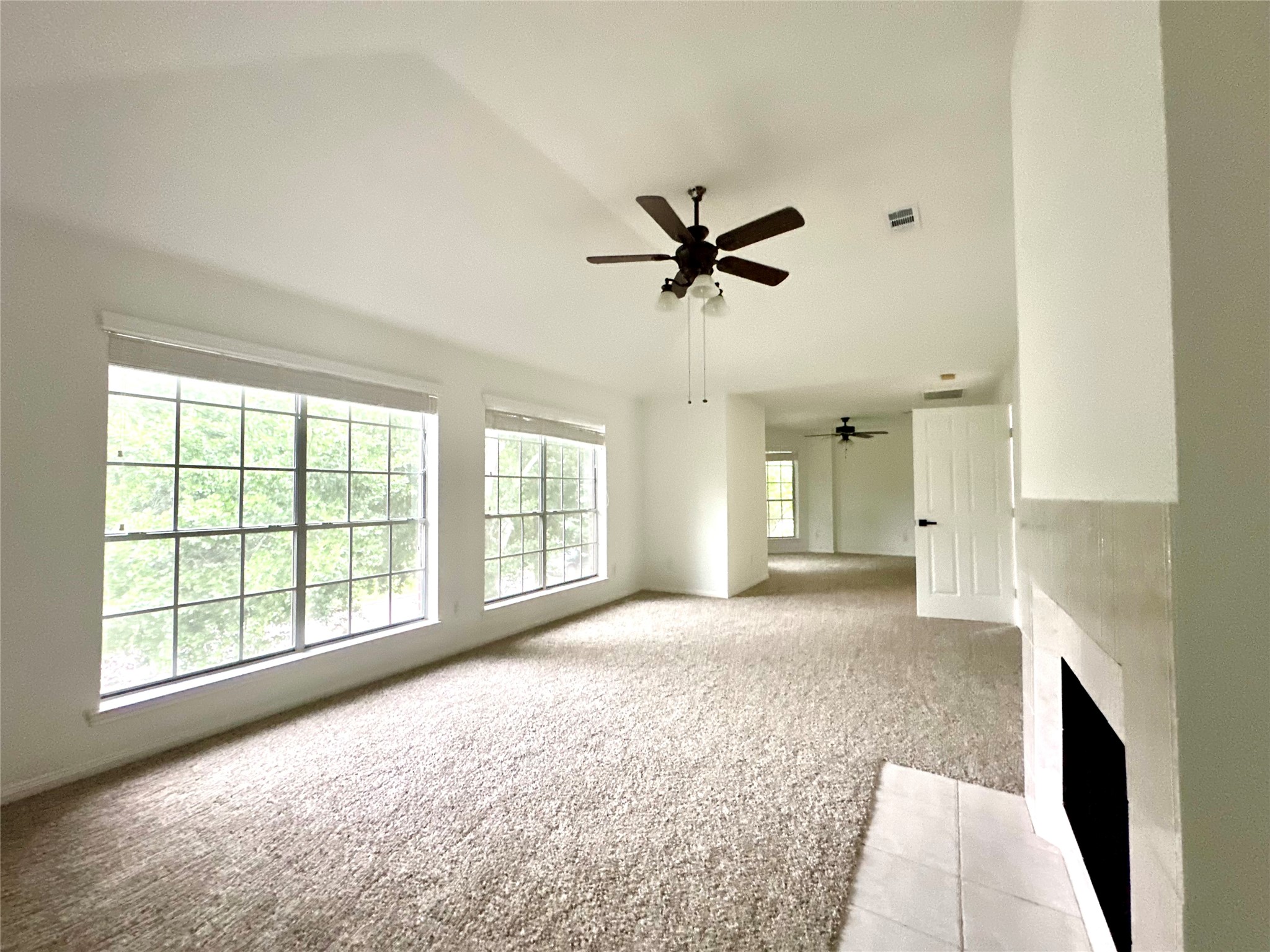24914 Aughton Court Spring, TX 77389 - Photo 4 of 27 Double-sized primary bedroom with a charming fireplace and spacious layout.
