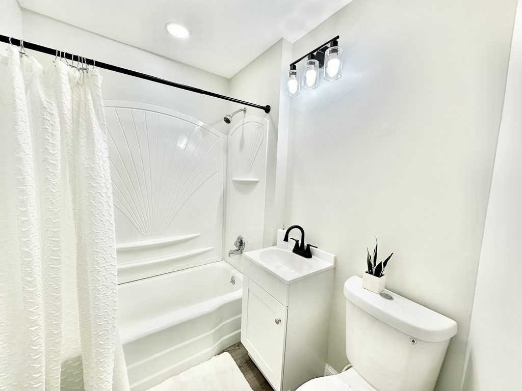 28-30 Kendall Street Springfield, MA 01104 - Photo 7 of 10 a white toilet sitting next to a bathroom sink and tub